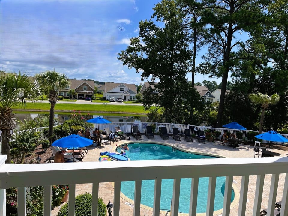 The private balcony overlooks a gorgeous pool and pretty pond. 