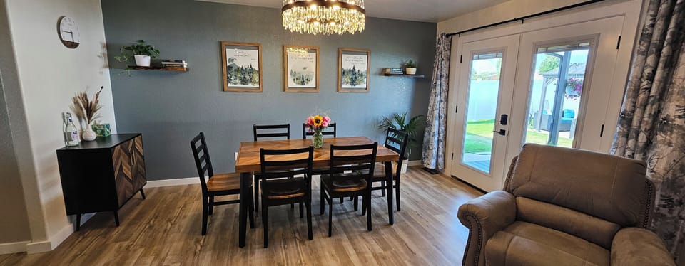 Dining area off of the living room, french doors open to deck and back yard.