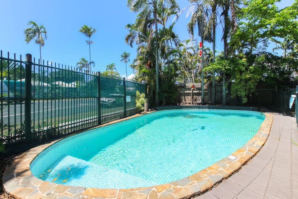 Pool Oasis: Dive into relaxation in this refreshing tropical retreat under blue skies!