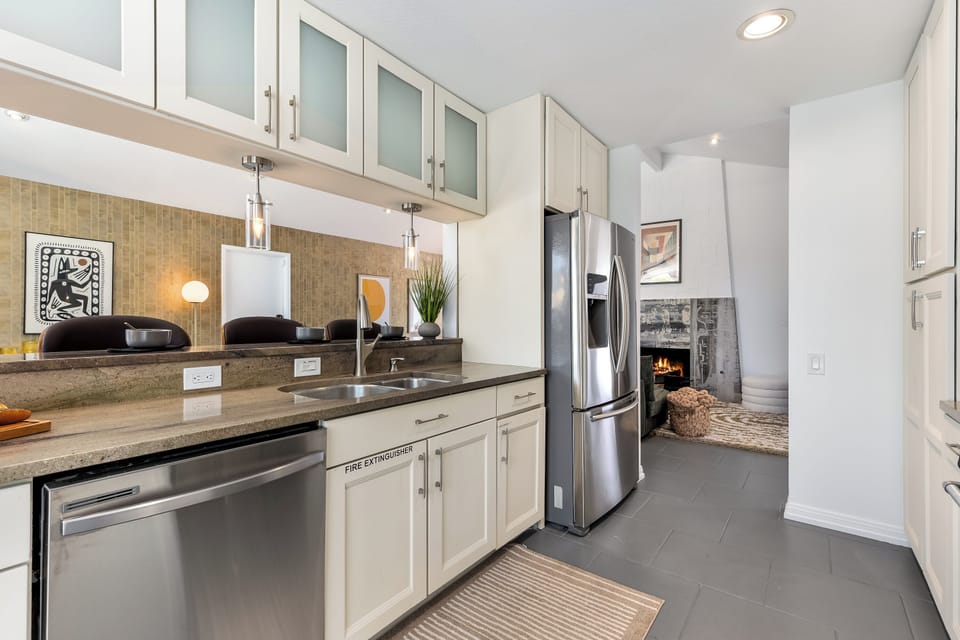 Lovely white cabinets host many culinary amenities
