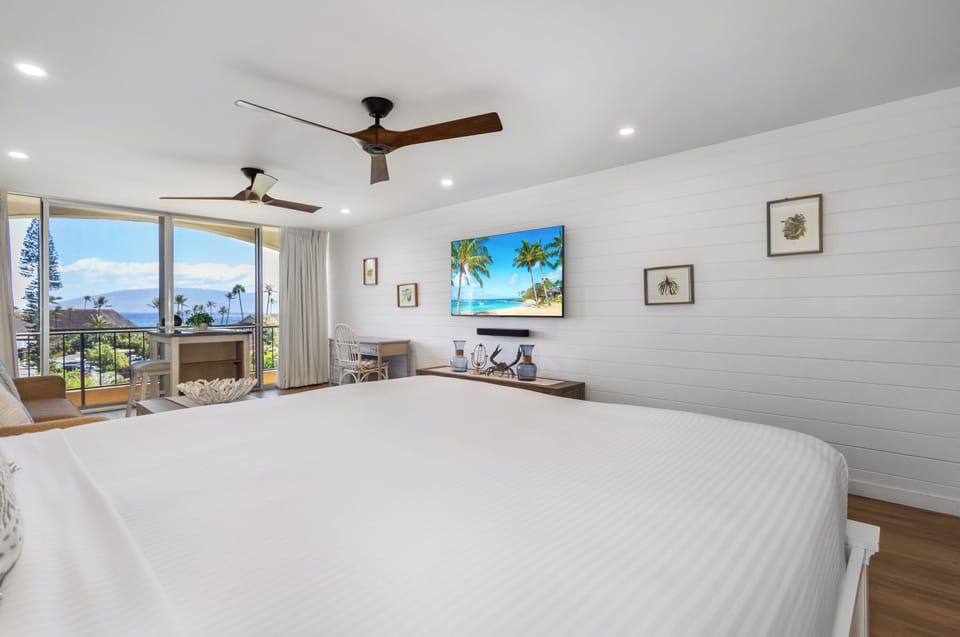 Wake up to stunning ocean views and gentle ceiling fans above your plush bed in this serene coastal retreat. Relax in your private space with tropical charm and modern comfort.