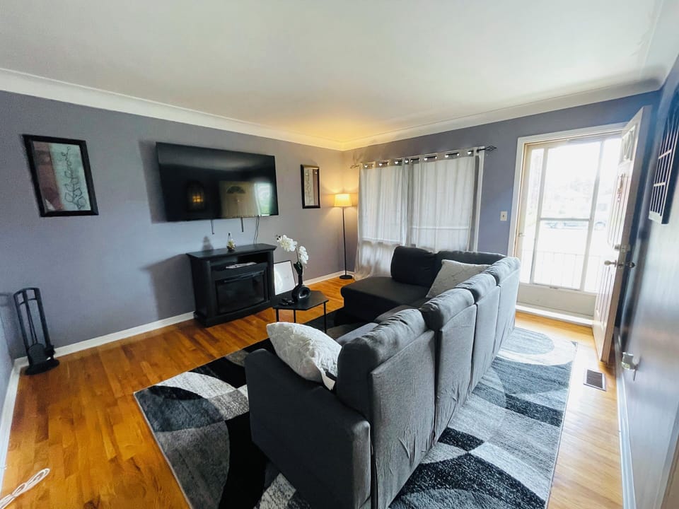 A 65 in TV is mounted on the wall to provide immersive viewing experience. 