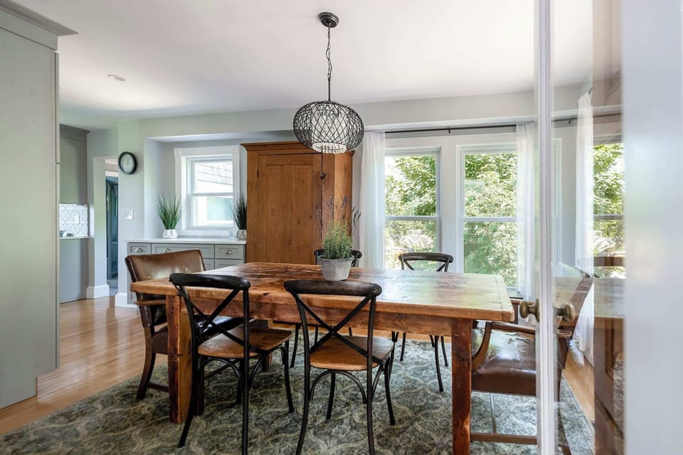 Modern dining space with large windows and bright ambiance