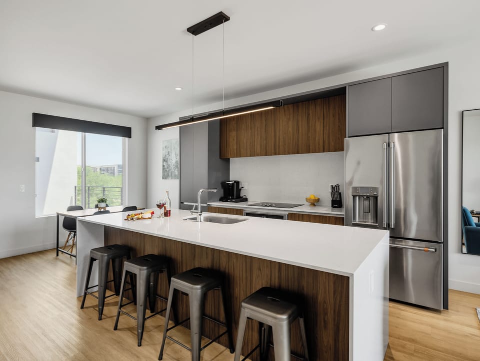 Unit 1 (1st Floor): Fully equipped modern kitchen completely stocked with all culinary essentials and includes high-end Cafe stainless steel appliances. Dining table offers a space for four.