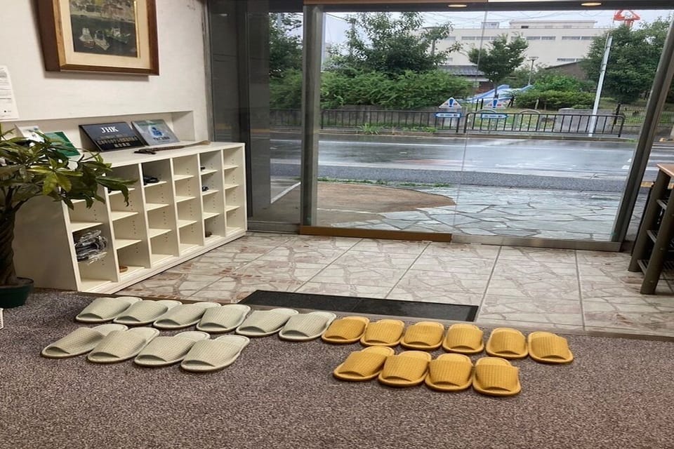 This is the entrance to our hotel. We have slippers ready for you.