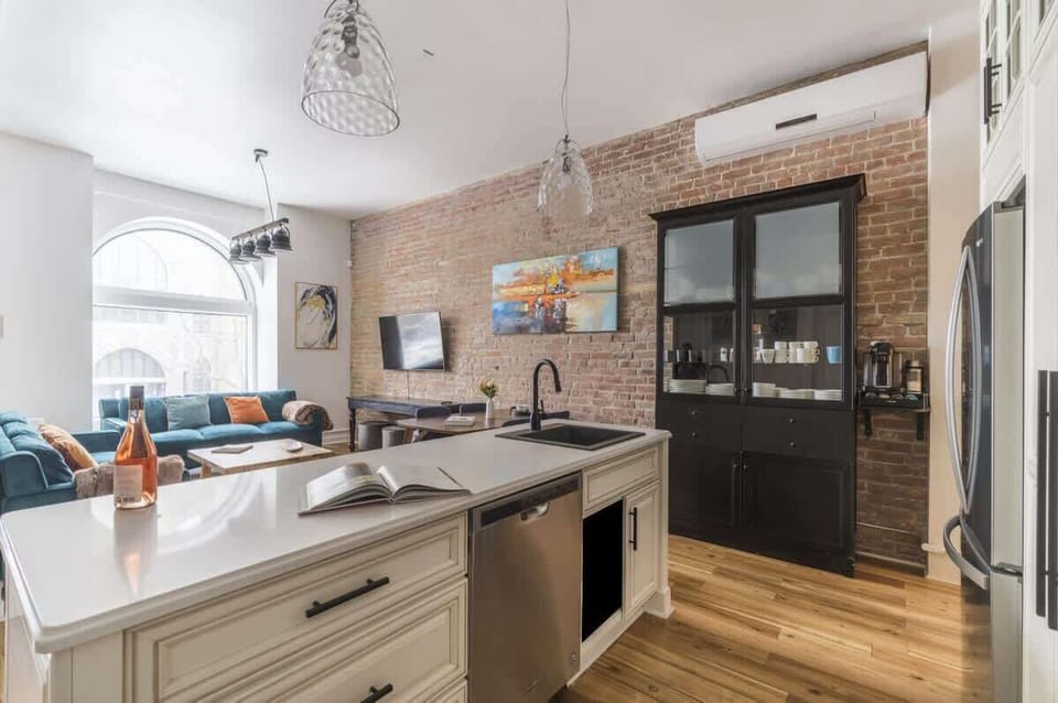 White countertop overlooking the dining and living areas—open and inviting.