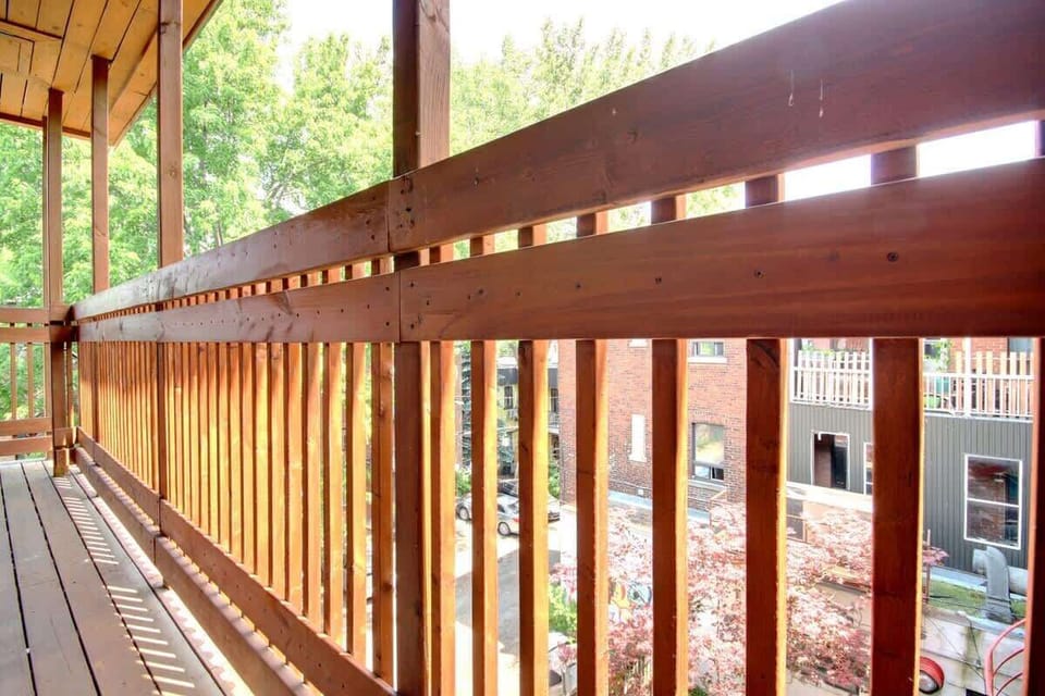 Cozy balcony featuring warm wood flooring and a stylish wood fence—ideal for enjoying your morning coffee or evening breeze.