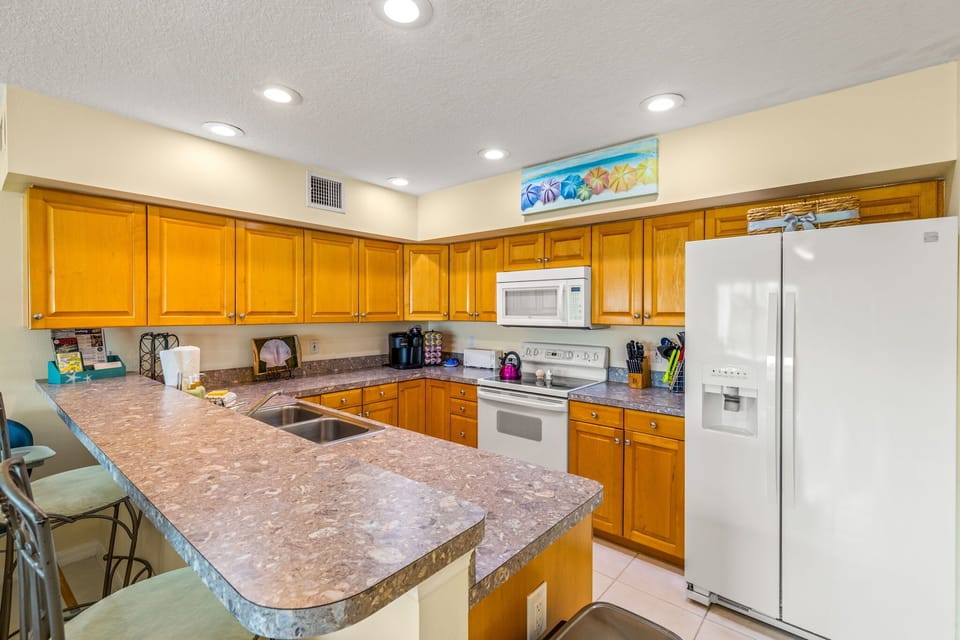 Our kitchen features sleek white appliances, including a spacious refrigerator