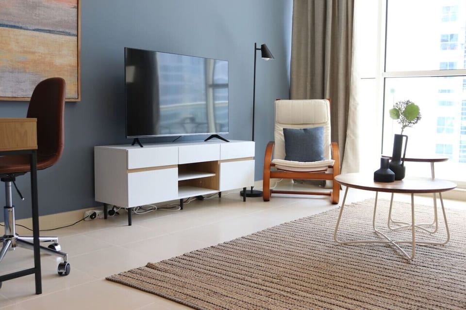 Elegant one-bedroom apartment in the Mayfair Building, Business Bay, featuring a chic living room with a canal view. Perfect for a holiday home in Dubai, vacation rental in Dubai, short-term rental in Dubai, or monthly rental in Dubai.