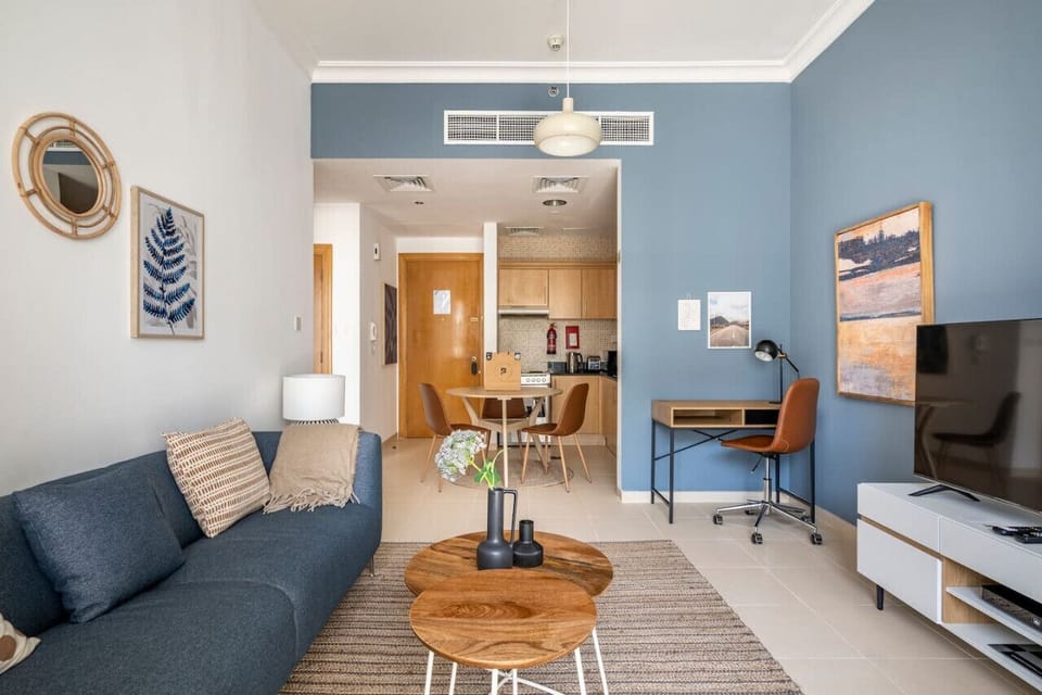Elegant one-bedroom apartment in the Mayfair Building, Business Bay, featuring a chic living room with a canal view. Perfect for a holiday home in Dubai, vacation rental in Dubai, short-term rental in Dubai, or monthly rental in Dubai.