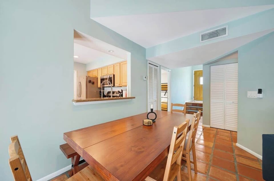 The dining area features a spacious 6-seater table, perfect for enjoying meals with family and friends.