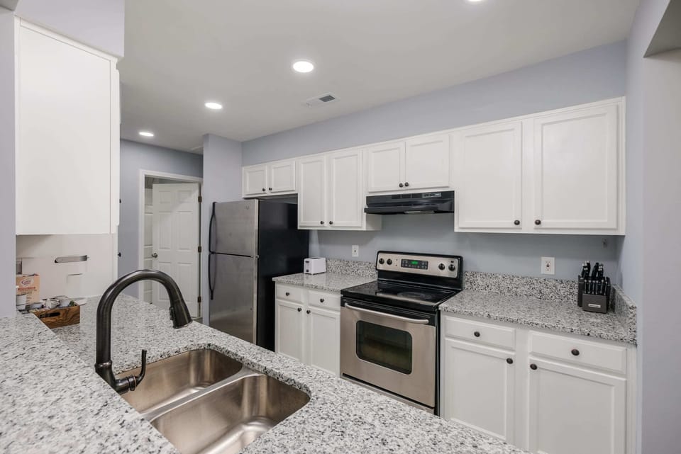 Fully stocked kitchen with modern appliances, cookware, coffee maker and everything needed for home cooked meals. 