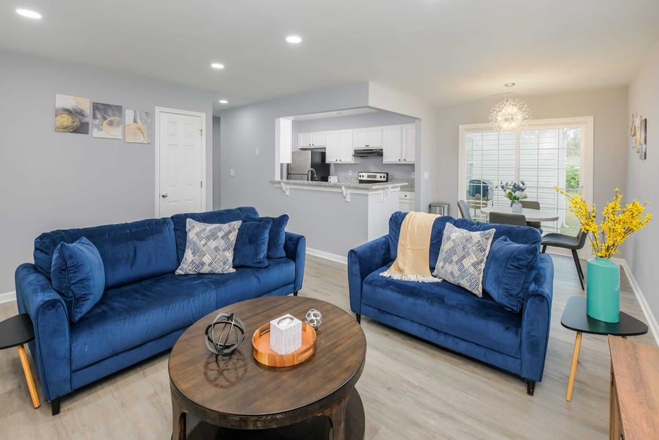 Gather the whole crew in the open living room—perfect for relaxing after a day in Uptown or settling in for movie night together.