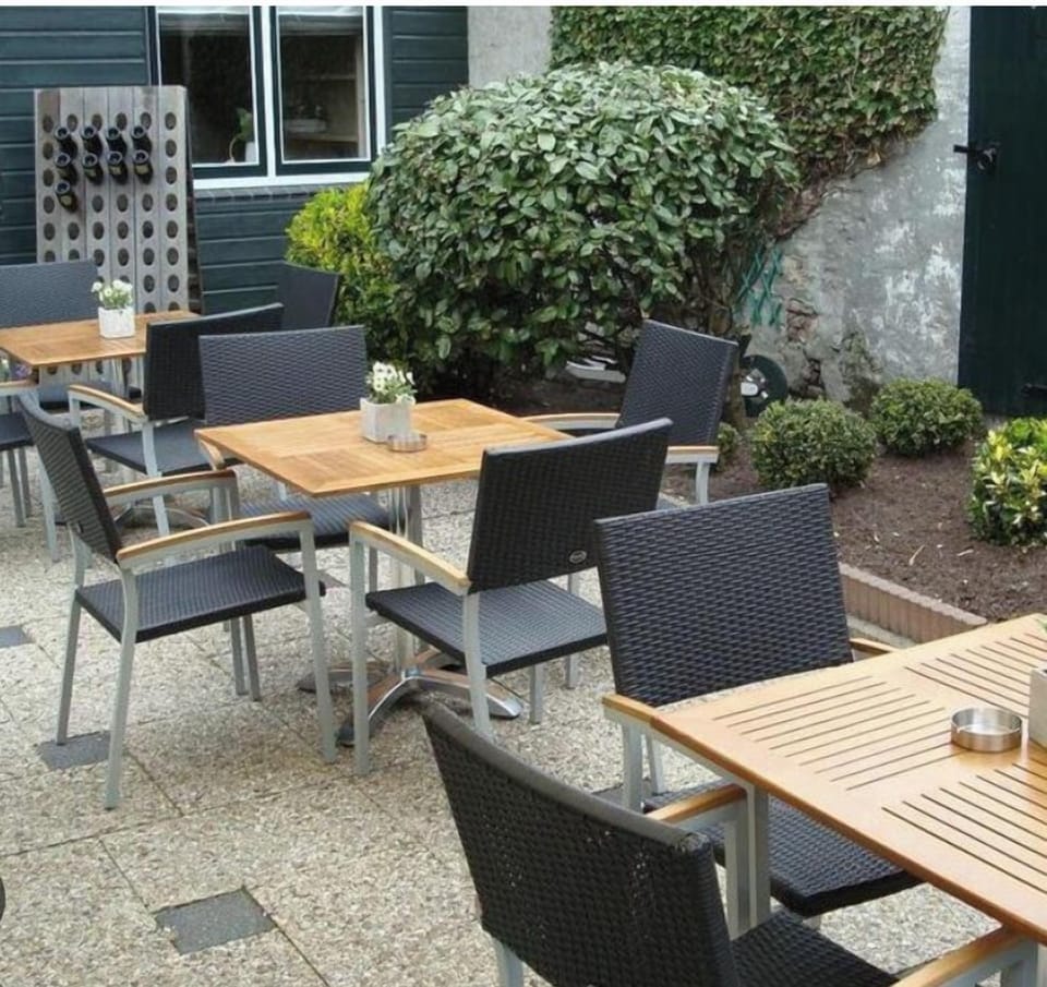 peaceful spot to relax with comfortable seating, perfect for enjoying a drink, reading, or simply unwinding in a tranquil outdoor setting.