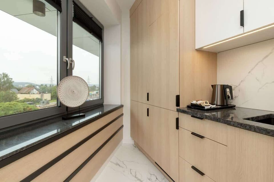 Kitchenette with oven and refrigerator. 