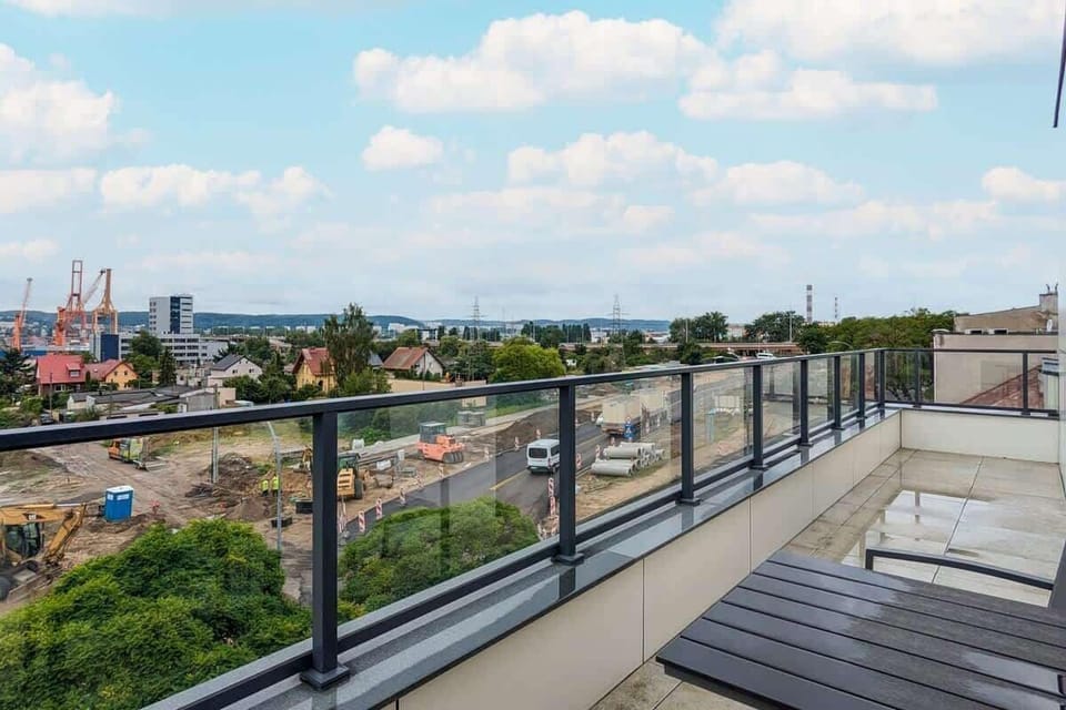 Spacious balcony with outdoor furniture. 