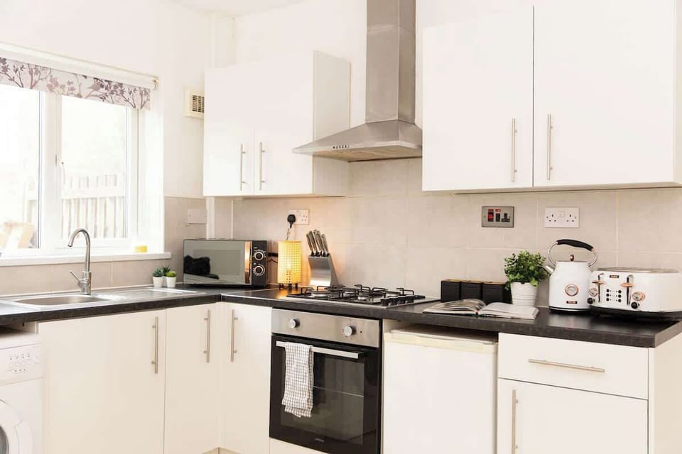 "A small yet sleek and minimalist kitchen, designed for both efficiency and style—perfect for preparing meals in a modern, clutter-free space."