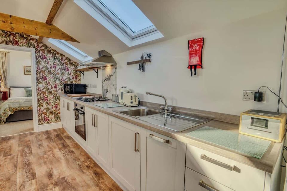 "Whip up your favorite meals in this charming minimalist kitchen—thoughtfully designed with sleek essentials and a warm, welcoming vibe."