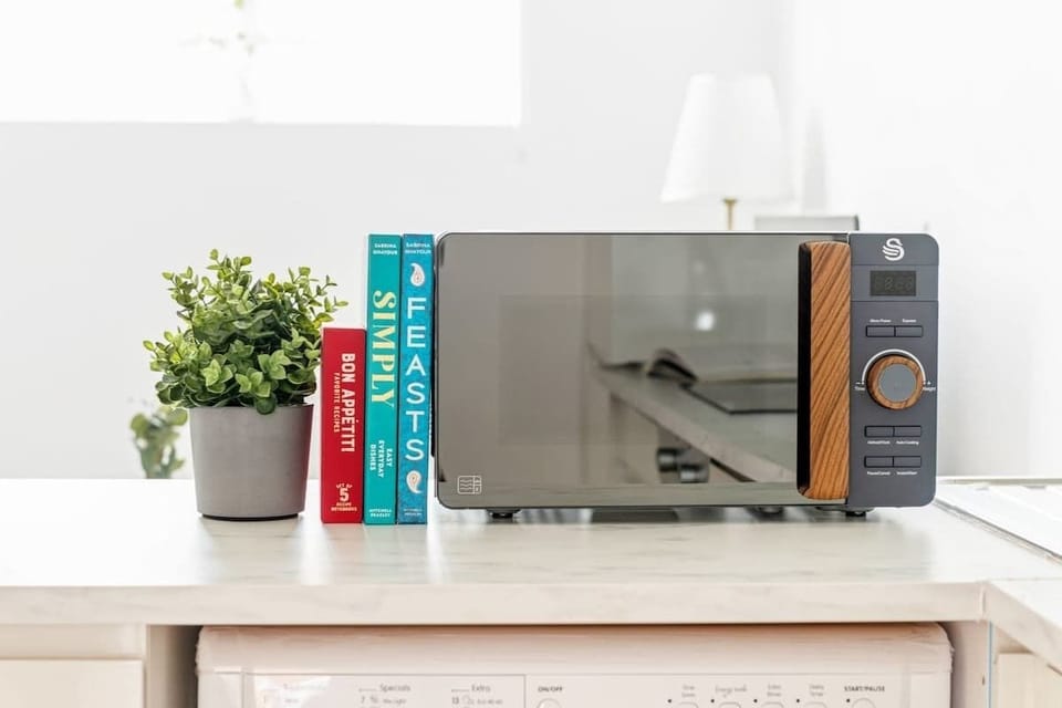 "A small yet sleek and minimalist kitchen, designed for both efficiency and style—perfect for preparing meals in a modern, clutter-free space."