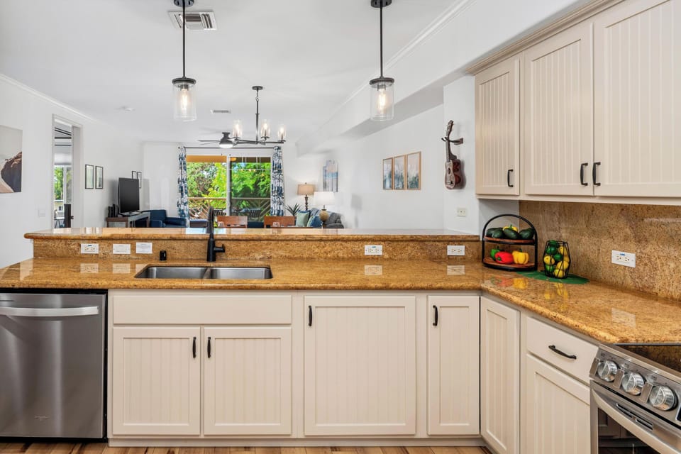 Full kitchen with breakfast bar, granite counters, and stainless steel appliances