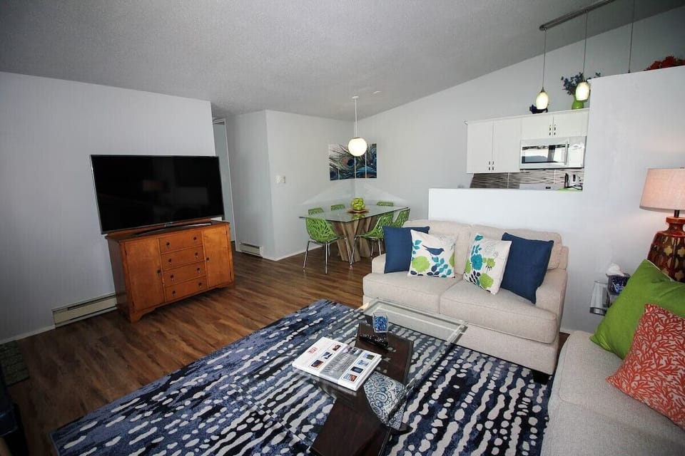 Living room with Smart TV connected to dining/kitchen area