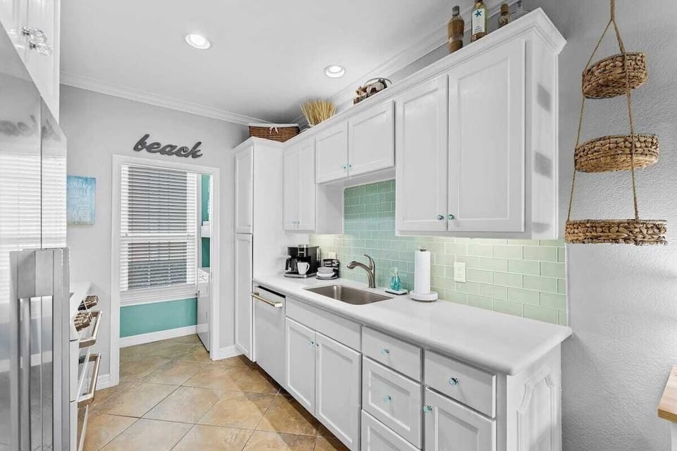 ... Quartz countertops, Sea-glass backsplash and cabinet knobs...