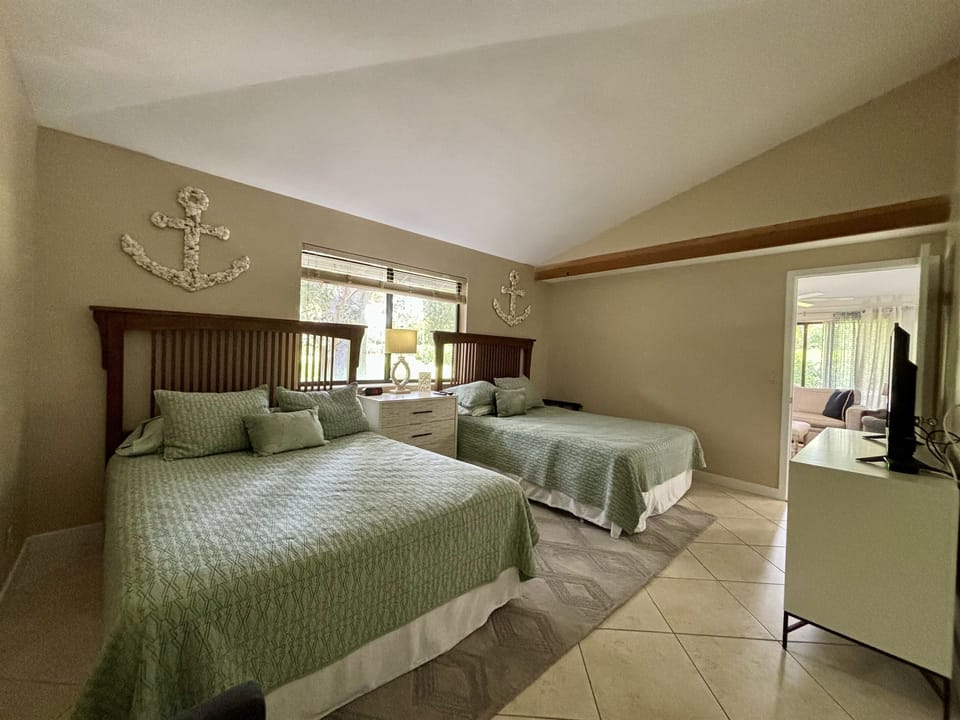 The Master Bedroom features two king beds, a TV, large closet and dresser with plenty of space for storage.