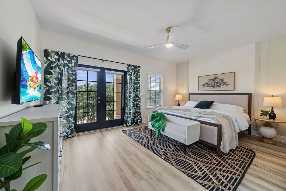 Additional bedroom with cozy bedding, ceiling fan, and elegant décor—ideal for guests seeking comfort and privacy.