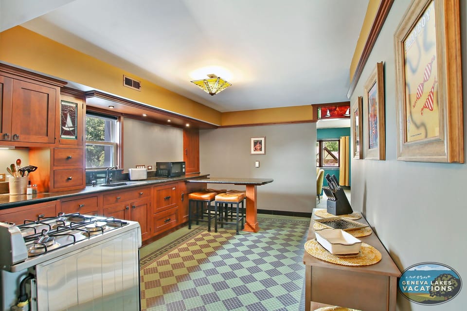 Kitchen with stove, small dishwasher/sink and island seating