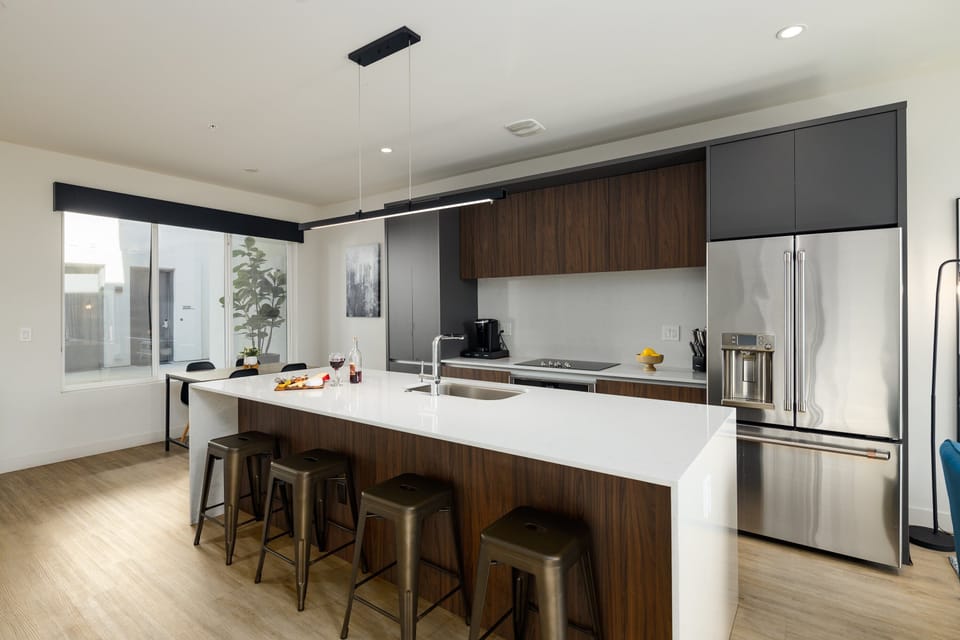 Unit 1 (1st Floor): Fully equipped modern kitchen completely stocked with all culinary essentials and includes high-end Cafe stainless steel appliances. Dining table offers a space for four.