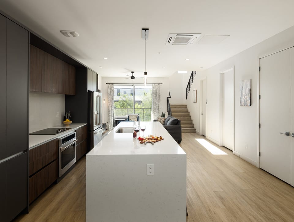 Unit 1 (1st Floor): Fully equipped modern kitchen completely stocked with all culinary essentials and includes high-end Cafe stainless steel appliances. Dining table offers a space for four.