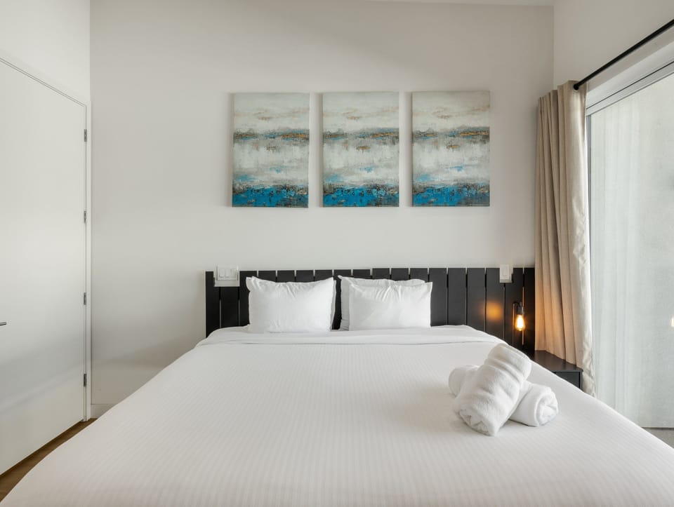 Unit 1 (2nd Floor): 2nd Bedroom featuring a King Bed, a Smart TV, a Private Balcony, and an ensuite bathroom.