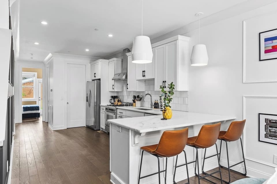 High-end appliances and all the cooking supplies you might need in this fully equipped kitchen with seating for three at the counter.
