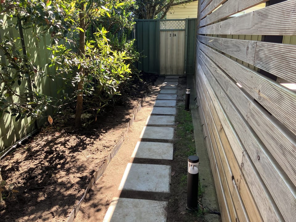 Private entrance pathway surrounded by native trees