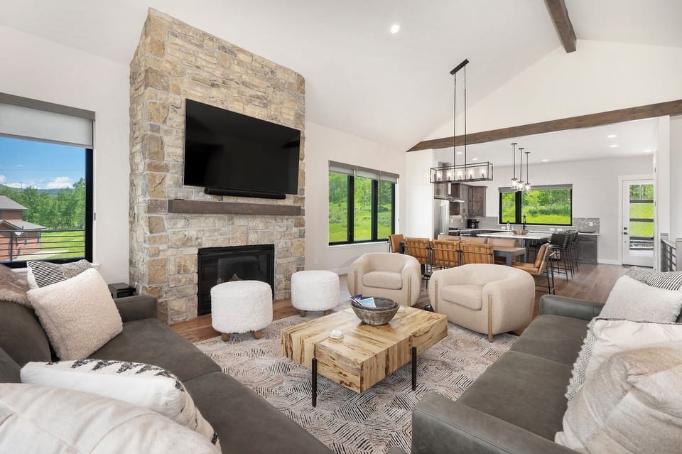 Main level living area with plenty of seating, fireplace, and amazing views