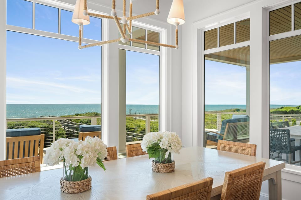 Gather around this stunning dining table where ocean views frame every meal, creating unforgettable moments with loved ones.