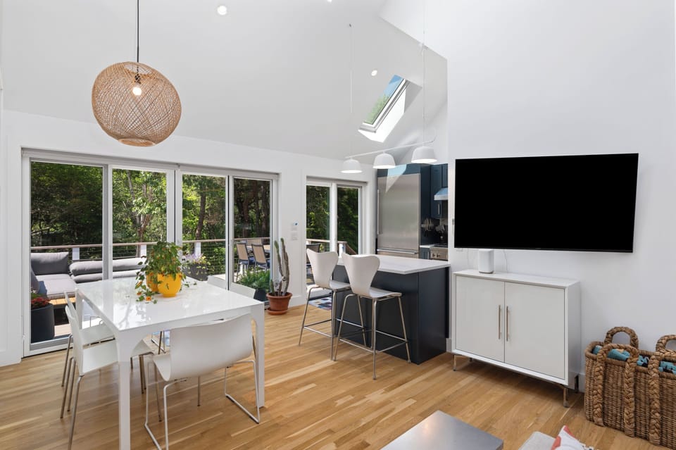 View of dining area and kitchen bar out to deck