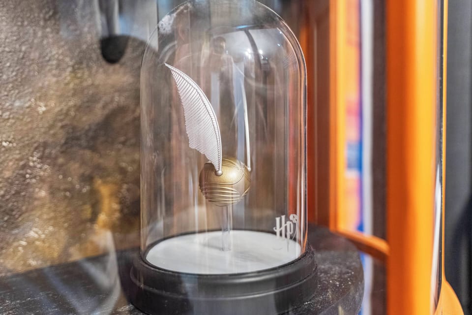 Discover a whimsical decorative piece featuring a delicate wing in a sleek glass cloche. Its natural textures and vibrant colors create a captivating focal point, enhancing your stay with charm and character.