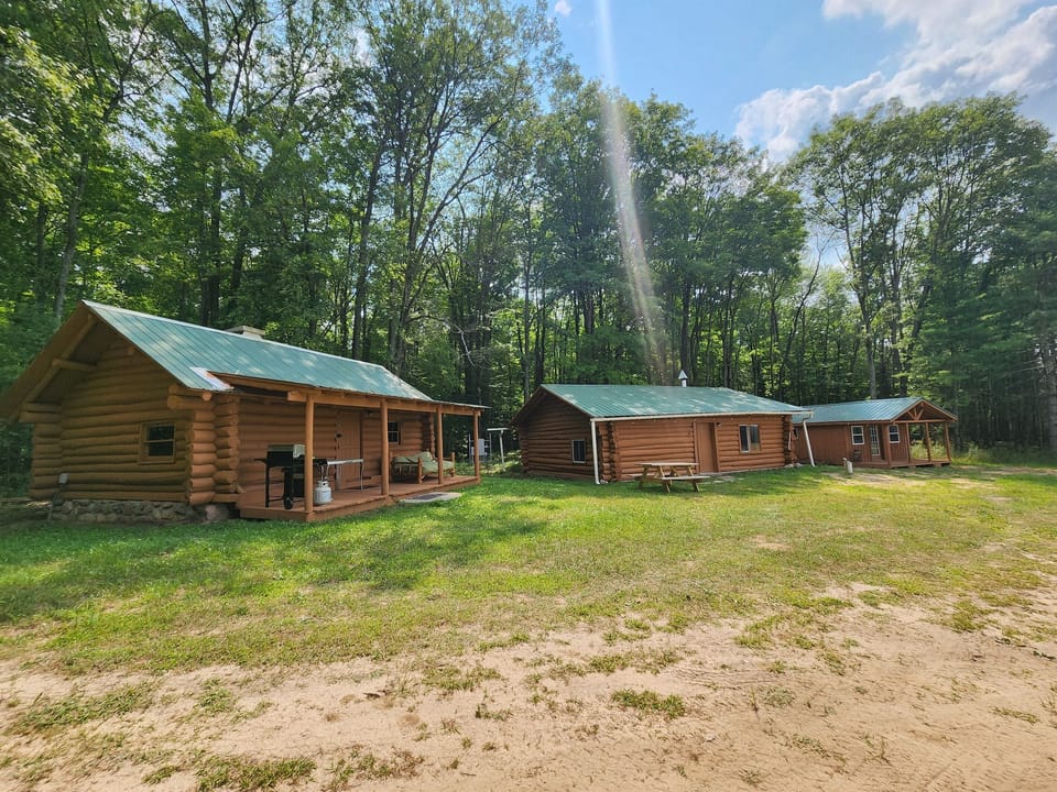 190 acres with 2 sleeping cabins & 1 cabin w/2 bathrooms & kitchen
