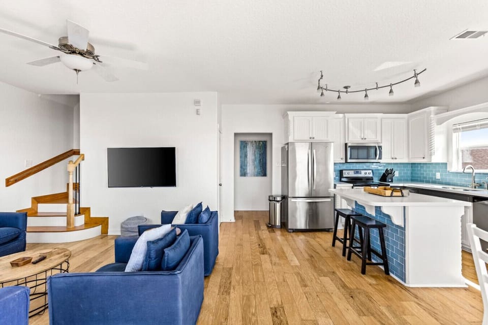 A spacious, open-concept living area with comfortable seating—ideal for unwinding after a day at the beach.