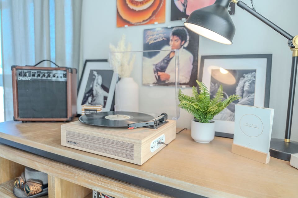 Record player with Vinyl's of popular artists for your listening pleasure.