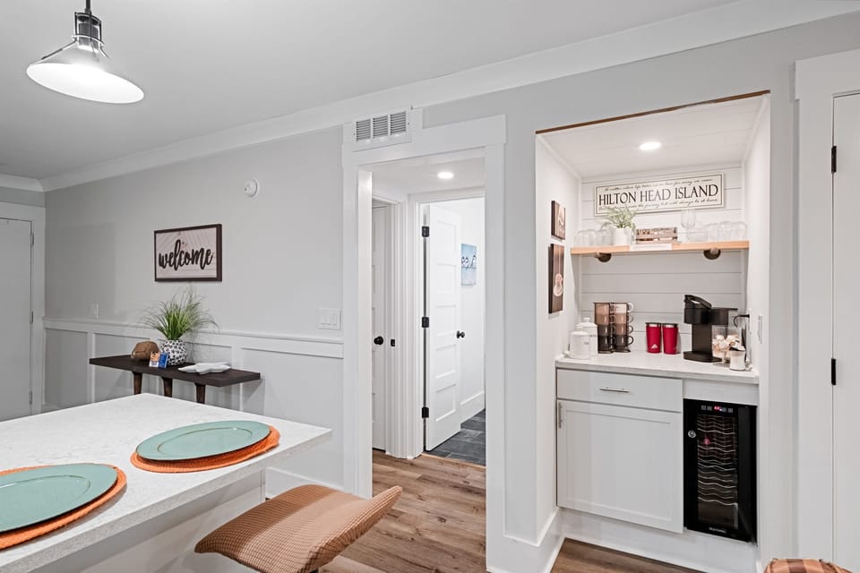 The coffee bar has a keurig and a coffee pot. We also provide some coffee, creamer, and sugar to get your vacation started. There is also a wine fridge.  