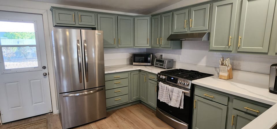 The deluxe refrigerator, toaster oven, Keurig, and all cooking utensils are here
