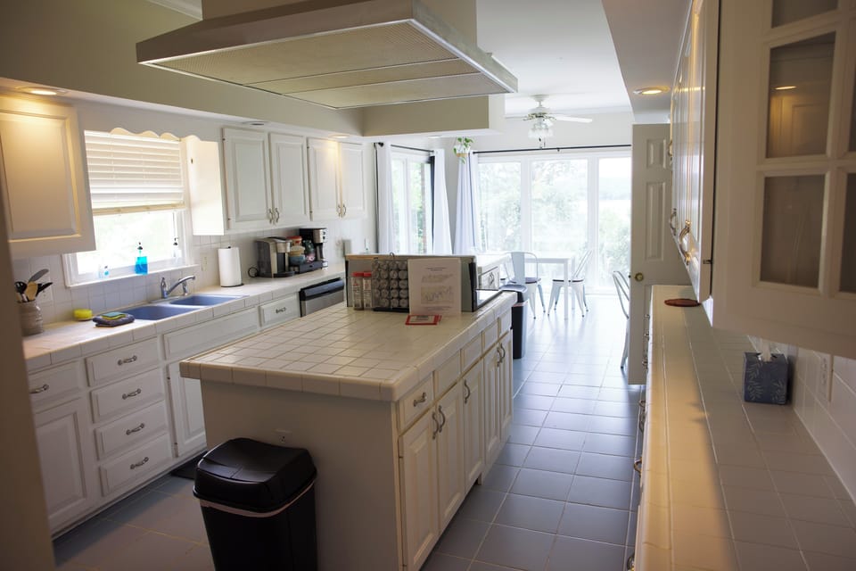 Full kitchen with breakfast nook, bar seating, mini office, and beautiful views.