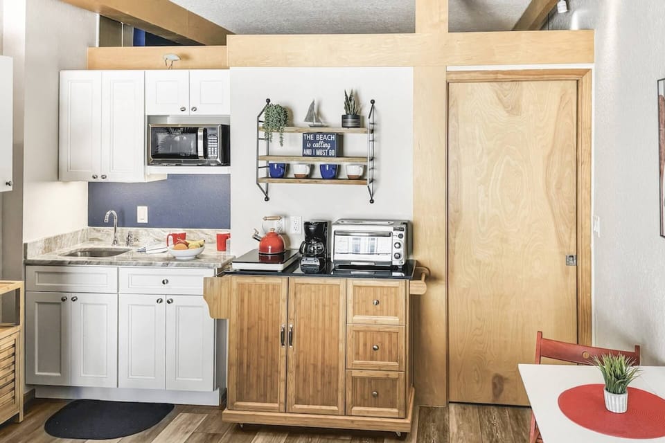 Enjoy the convenience of a fully equipped kitchen, featuring refrigerator, microwave, coffee maker, cooktop, toaster oven, dishware and utensils.