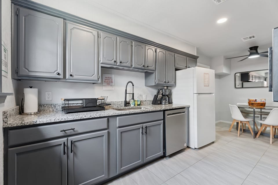 Stocked kitchen includes a full-size fridge, dishwasher, and plenty of counter space for easy meal prep.