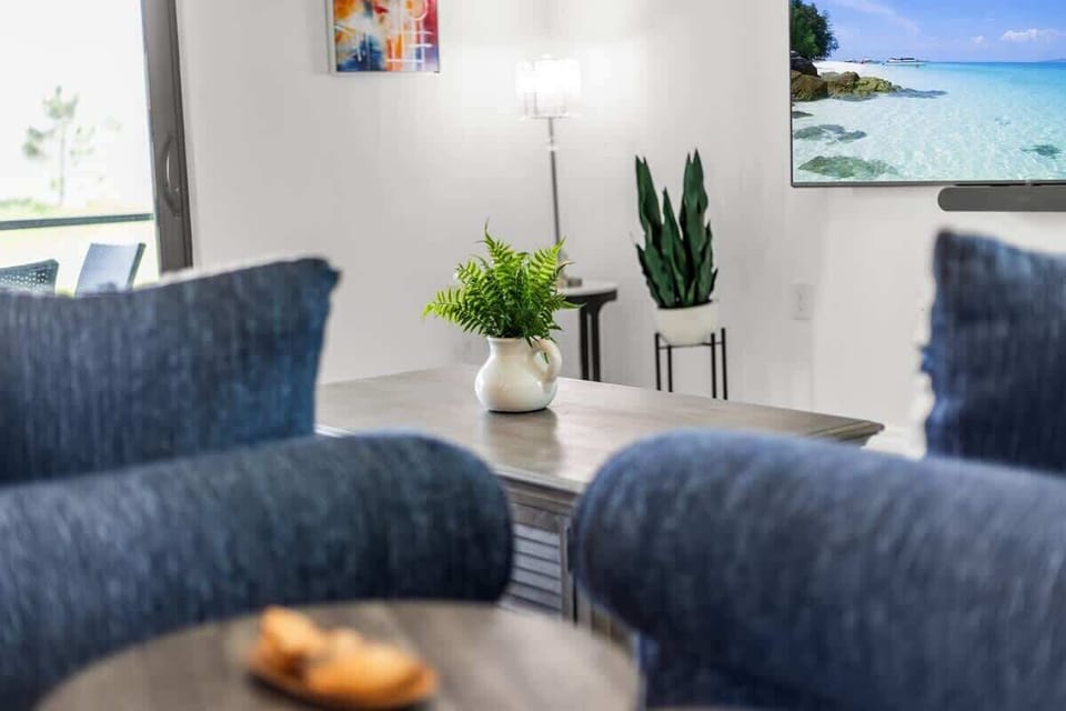 "Relax in the living room with charming decor and natural light."