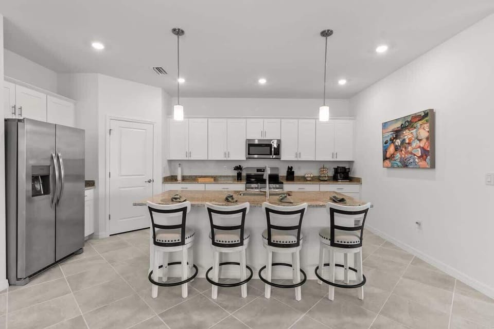 "Spacious and Inviting Kitchen with Bar Seating"