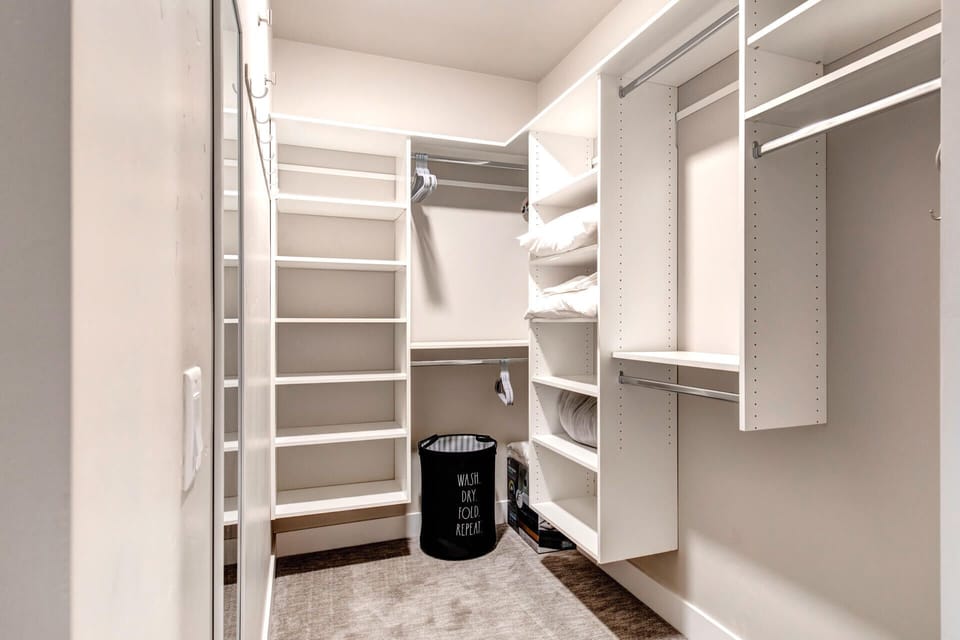Your walk-in closet awaits with organized shelving, hanging space, and ample room to unpack and feel right at home during your stay.