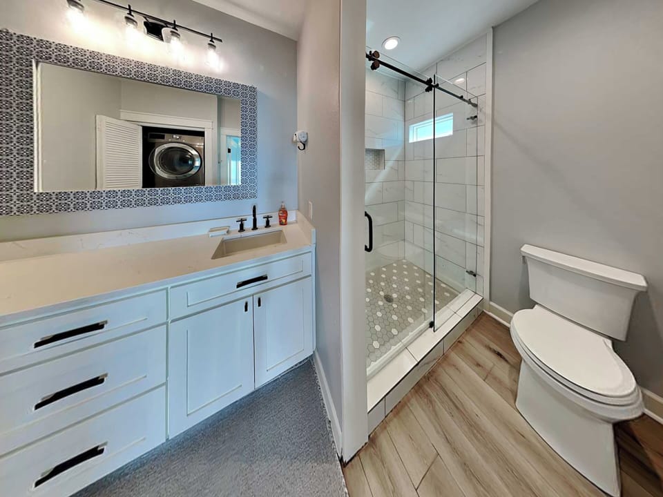 First Bathroom (Primary) - Walk-In Shower + Laundry